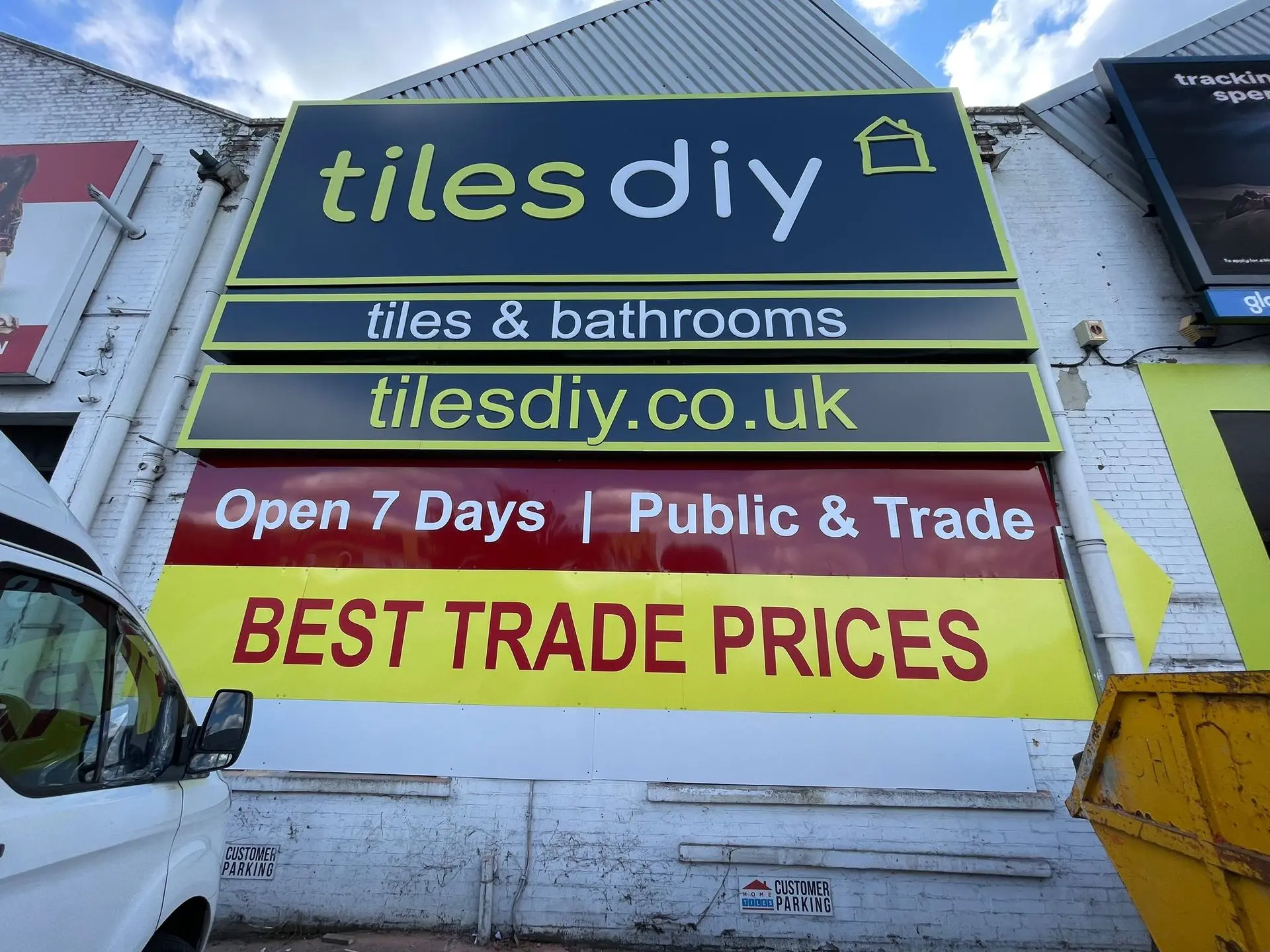 Promotional signage for Tiles DIY to attract customer attention Colourful promotional banner for Tiles DIY highlighting trade prices and offers