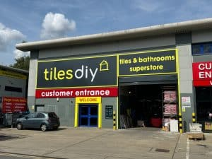 Tiles DIY storefront with newly designed signage by Sign Architects, featuring customer entrance and bold branding.