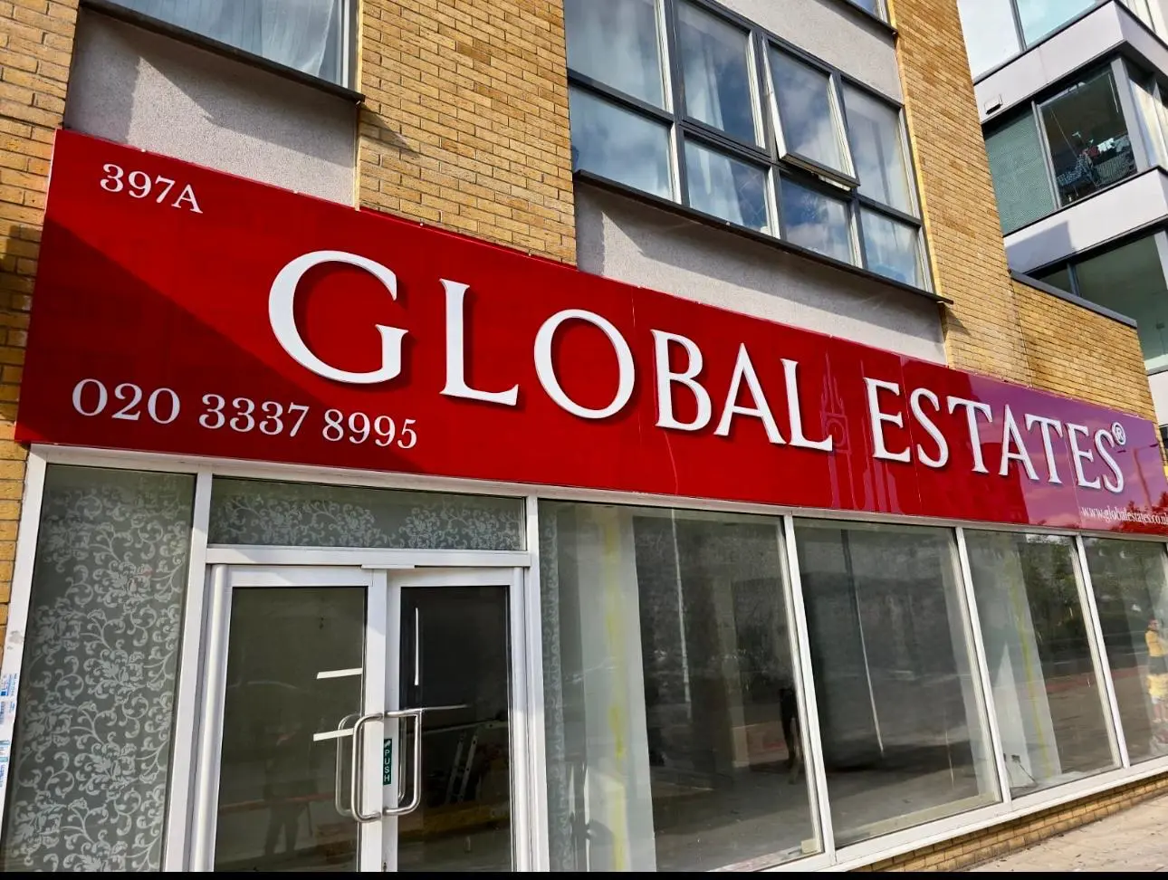Push through illuminated shop front sign for Global Estates in London, featuring acrylic letters with LED illumination and aluminium composite box.