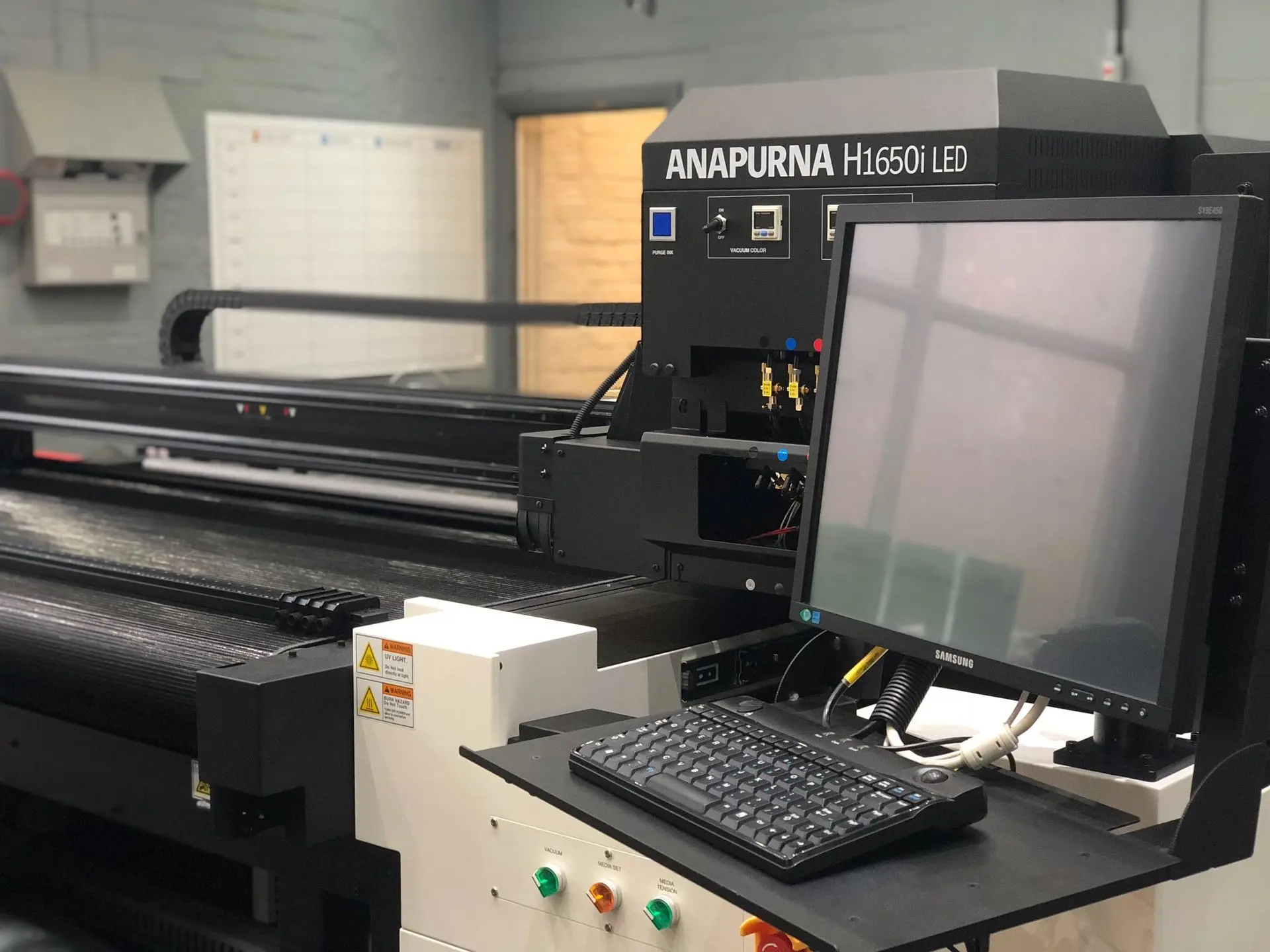 Flatbed UV Printer by Sign Architects for vibrant, durable signage Agfa Anapurna Flatbed UV Printer creating high-resolution prints for signage