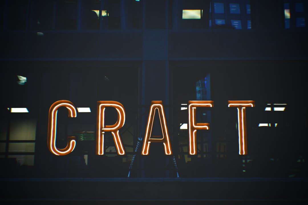 Neon CRAFT sign glowing at night